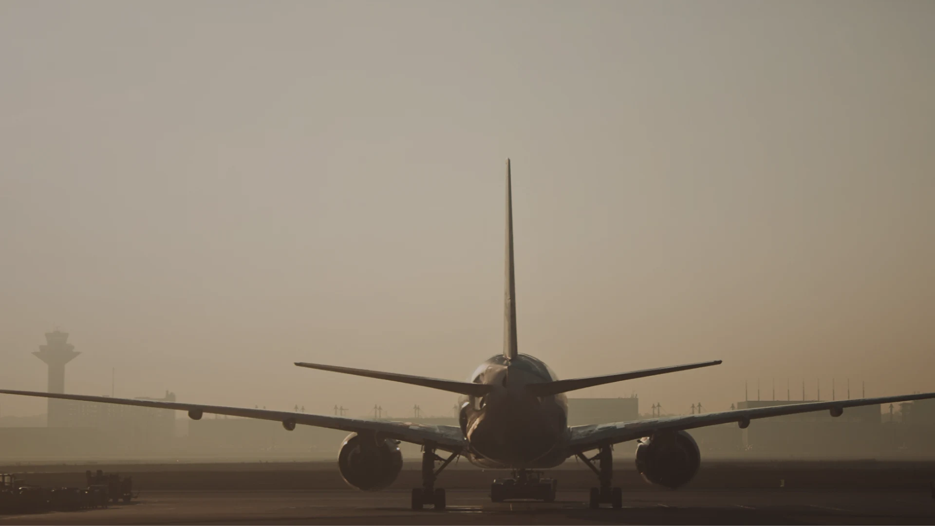 Airplane approaching a runway at sunset, representing a private transfer to Frankfurt Airport from Ramstein